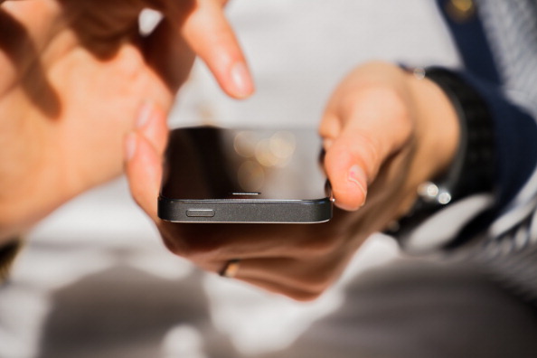 Woman with iPhone 5s checking all time his smartphone with internet connection. Internet addiction.